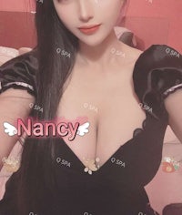 a girl in a black dress is posing for a picture